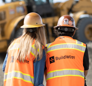 two people wearing a hardhat and a reflective vest